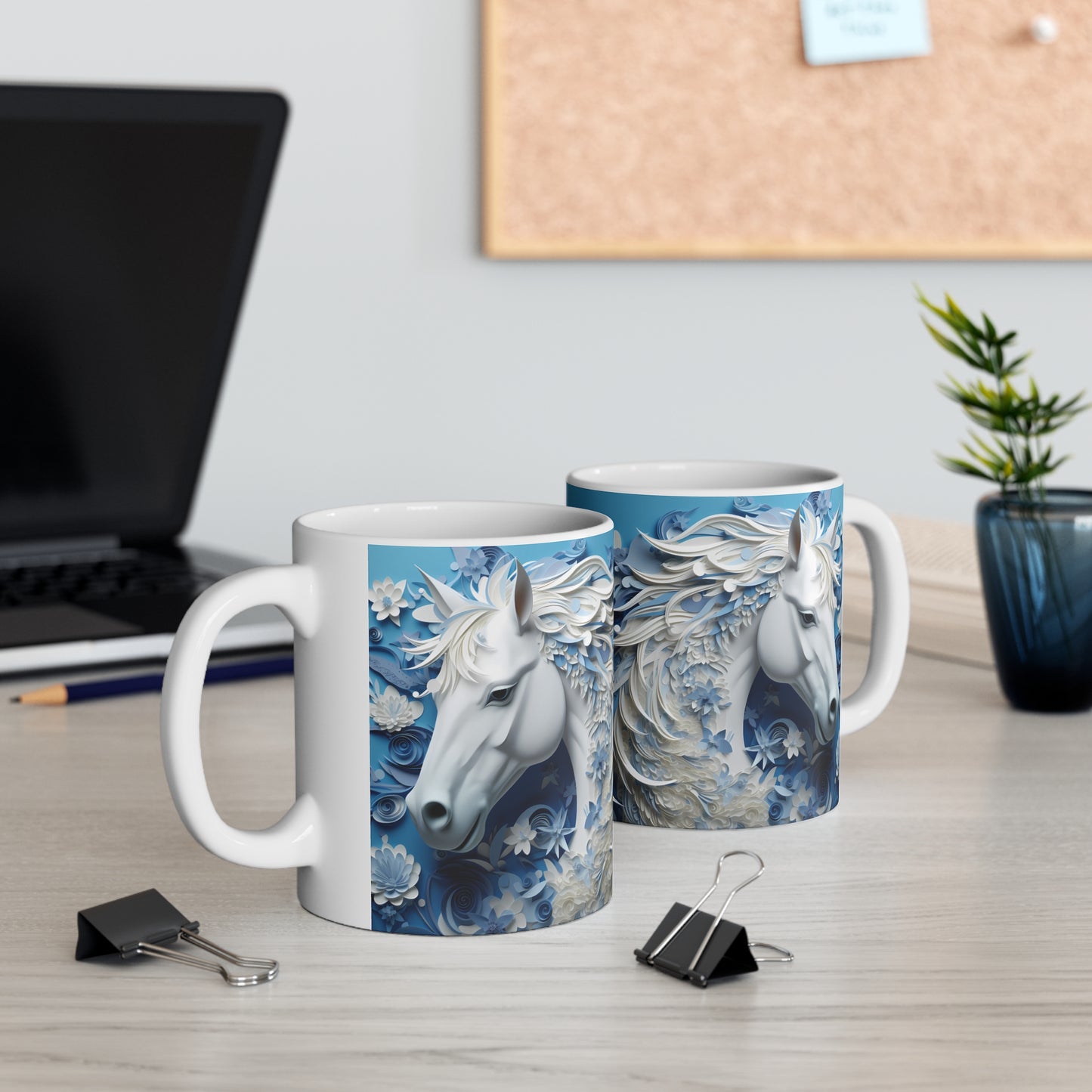 White ceramic mug featuring a sculpted-style white horse with flowing blue and white floral mane on a cool blue background. 11oz, microwave and dishwasher safe.