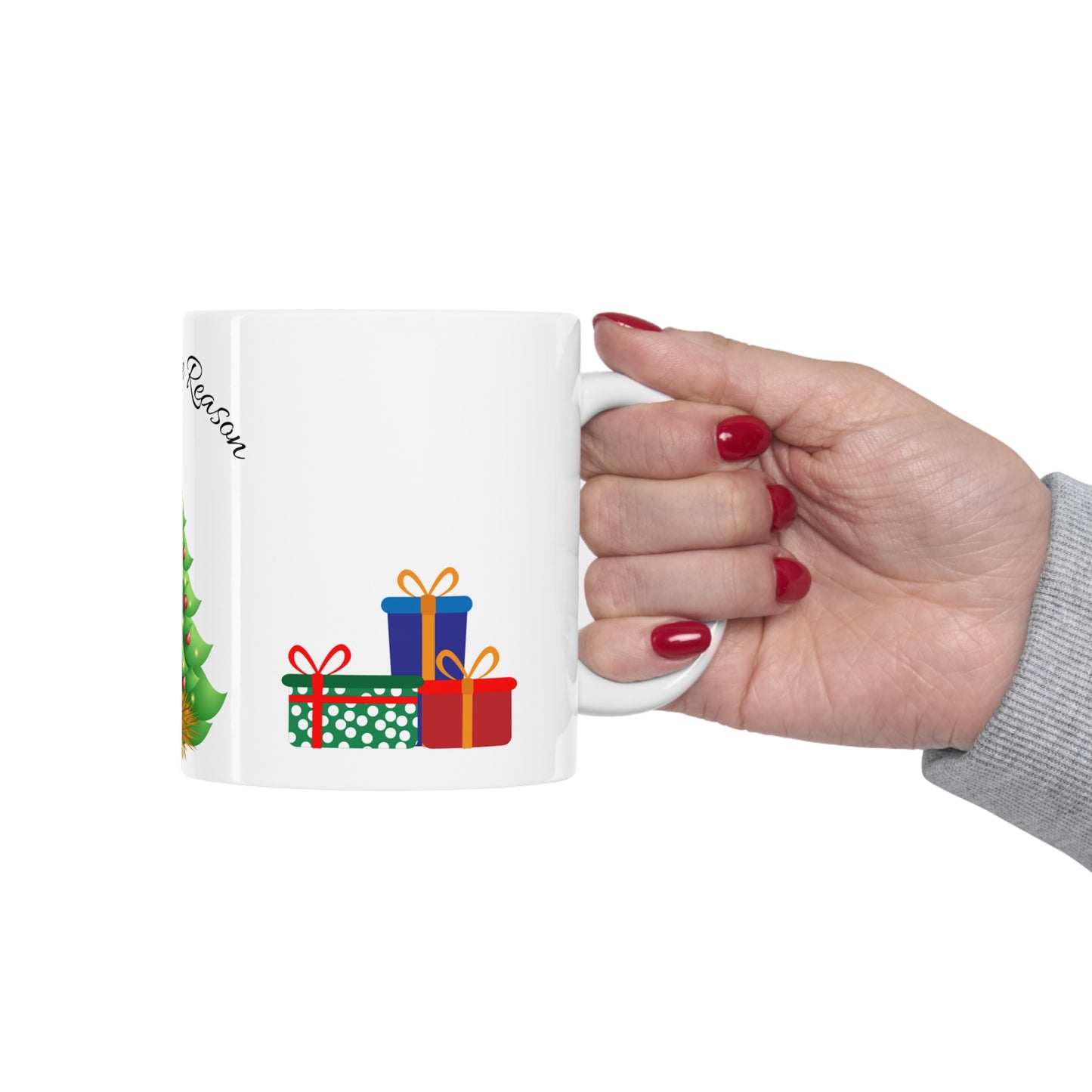 Christmas mug with baby Jesus, decorated tree, gifts, and “Jesus is the Reason” text