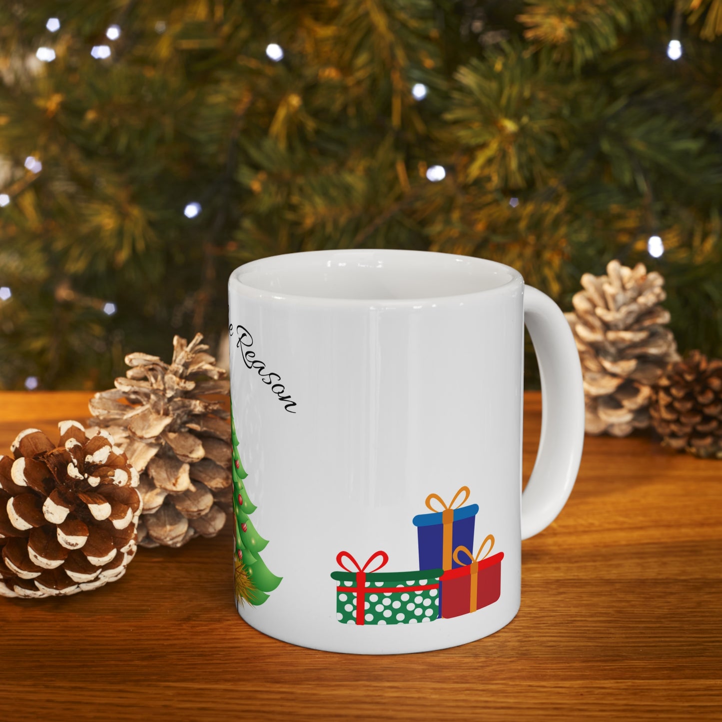 Christmas mug with baby Jesus, decorated tree, gifts, and “Jesus is the Reason” text