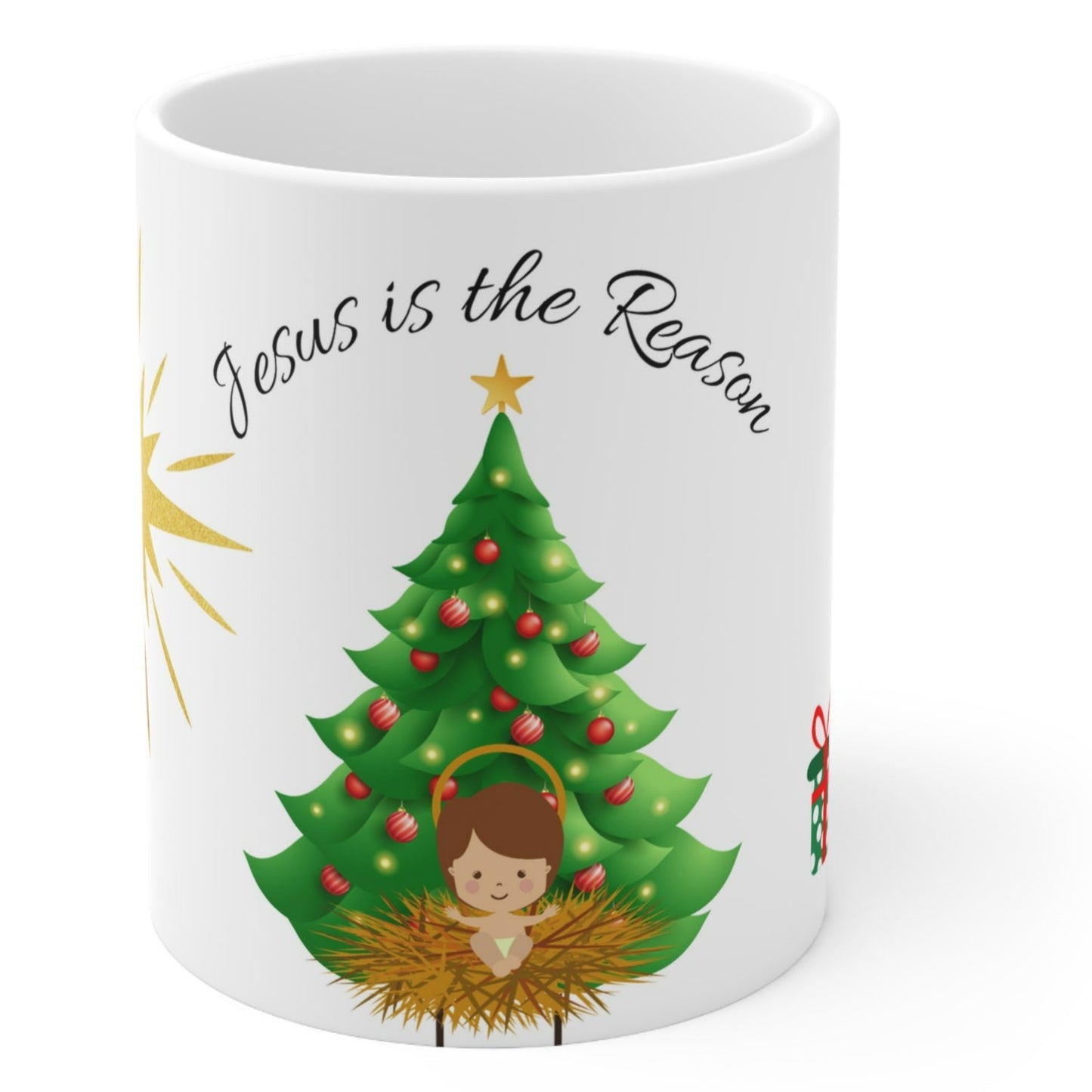 Christmas mug with baby Jesus, decorated tree, gifts, and “Jesus is the Reason” text