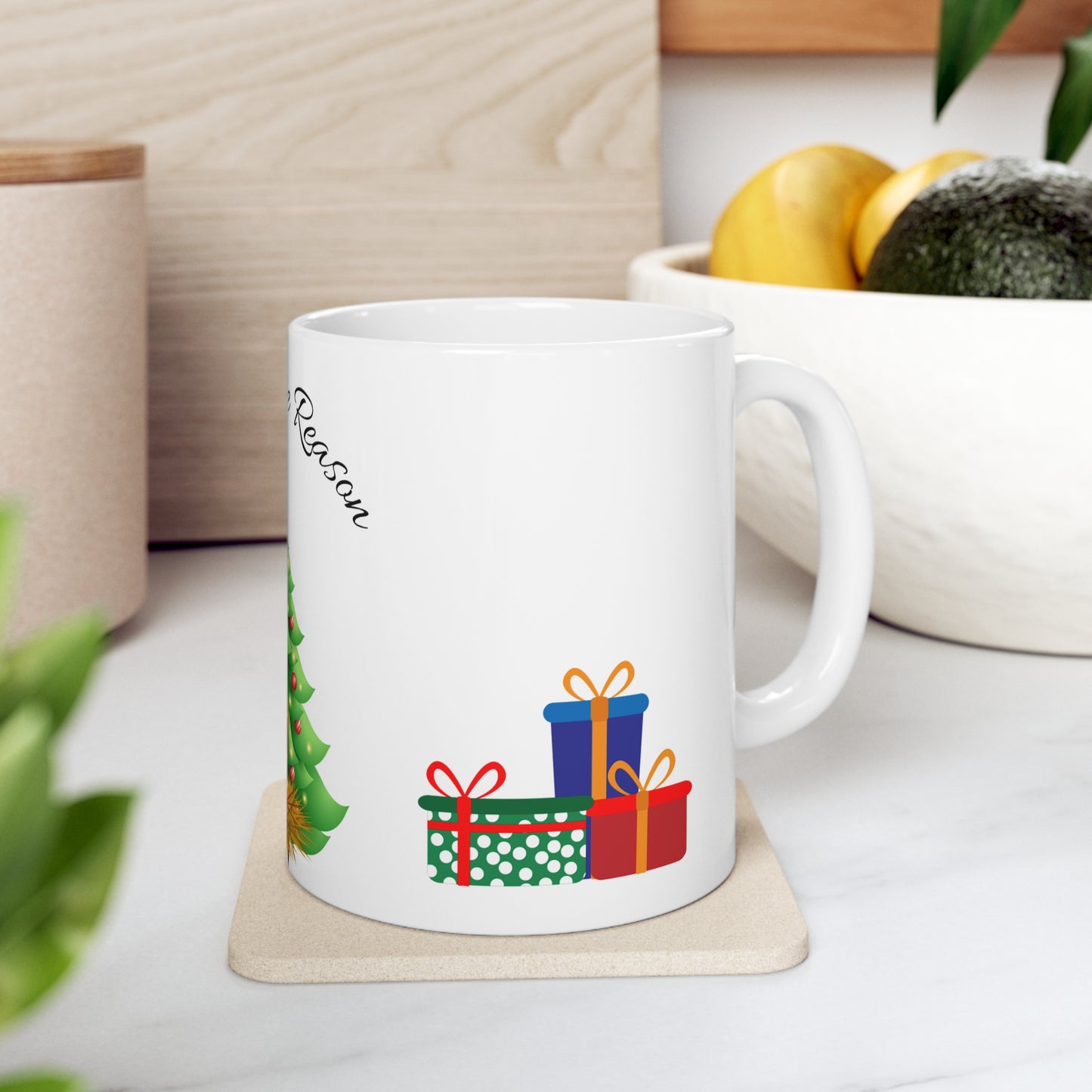 Christmas mug with baby Jesus, decorated tree, gifts, and “Jesus is the Reason” text