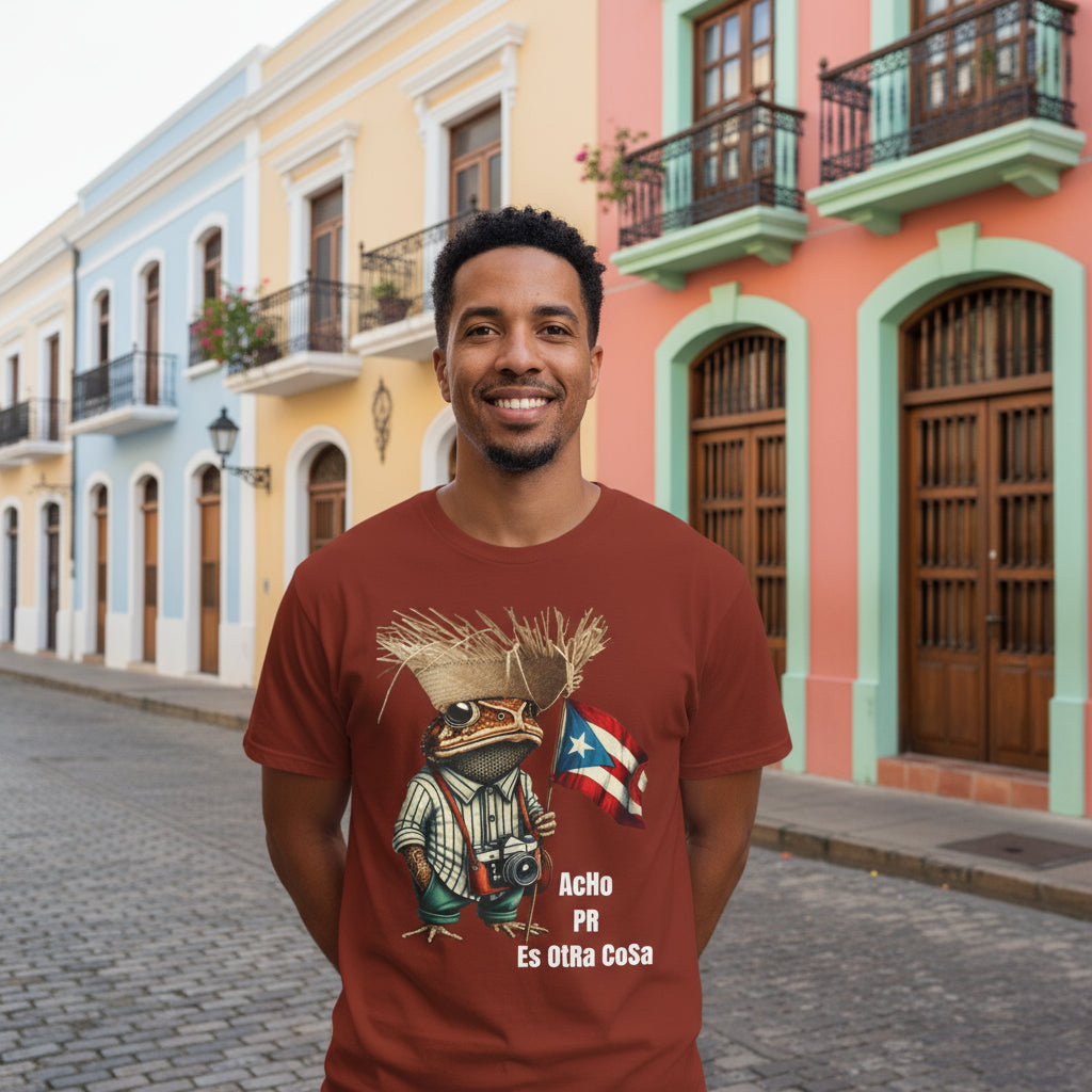 Brown t-shirt with a graphic of a SAPO CONCHO holding a Puerto Rican flag and text ACHO PR ES OTRA COSA on a white background