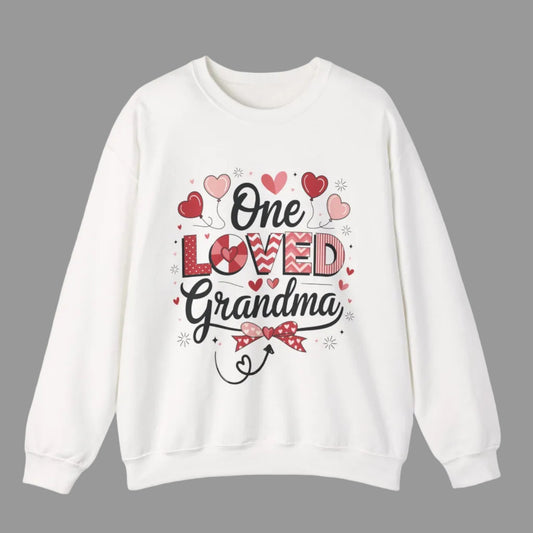 White sweatshirt with 'One Loved Grandma' text and heart designs on a white background